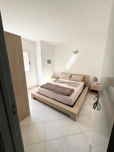 a bedroom with a bed in a white room at Blue Oceano in Santa Maria