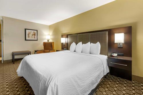 a large white bed in a hotel room at Best Western Plus InnTowner Madison in Madison