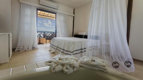 Postel nebo postele na pokoji v ubytování Bruno Marambaia Charme Hotel