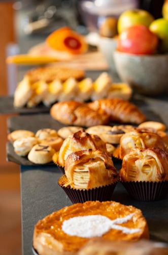 a bunch of muffins and pastries on a table at Amaranto Bed & Breakfast in Cavour
