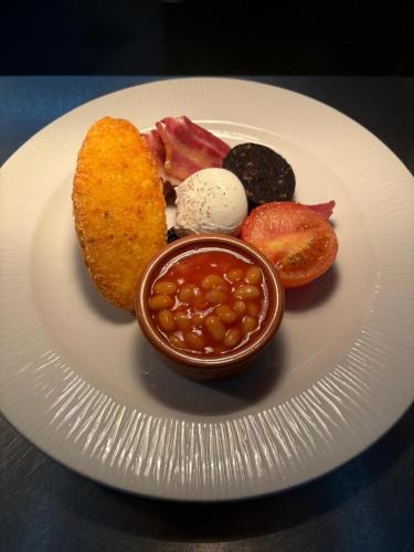 a plate of food with beans and other foods at The Castle Coaching Inn in Trecastle