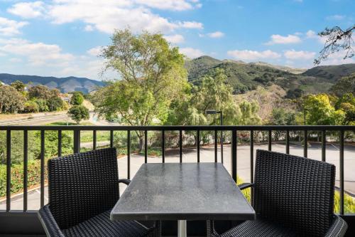a table and chairs on a balcony with a view at La Cuesta Inn, BW Signature Collection in San Luis Obispo