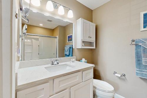 a bathroom with a sink and a toilet and a mirror at Colony Club C1 in Gulf Shores