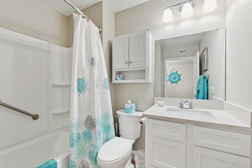 a white bathroom with a toilet and a sink at Colony Club C1 in Gulf Shores