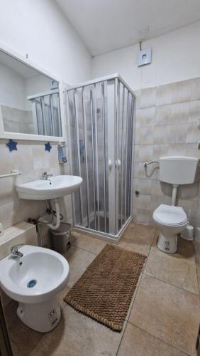 a bathroom with a sink and a toilet and a shower at Nuccia'S House in Reggio Calabria
