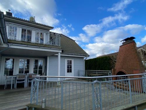a house with a deck and a brick building at Villa Recknitztal Marlow in Marlow