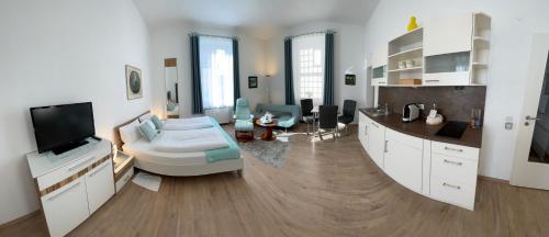 a large living room with a couch and a tv at Die Trauminsel 2 in Lindau