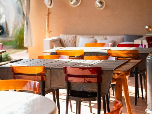 a group of tables and chairs in a restaurant at Villa Roswell Marrakech in Marrakech