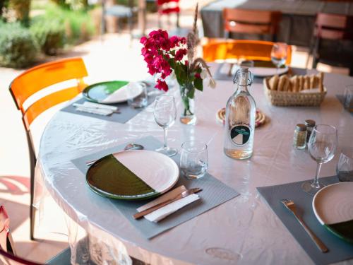 a table with a white table cloth and a bottle of wine at Villa Roswell Marrakech in Marrakech