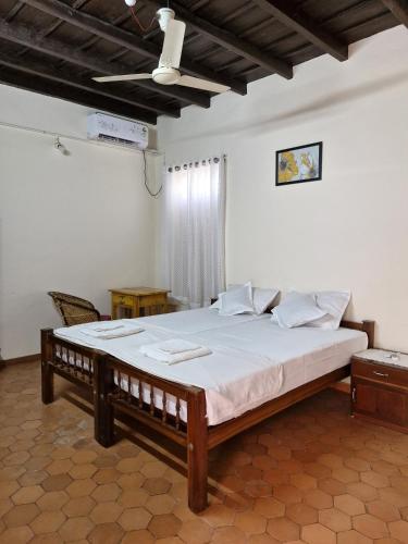 a bedroom with a large bed in a room at Philosopher's Stone in Varkala