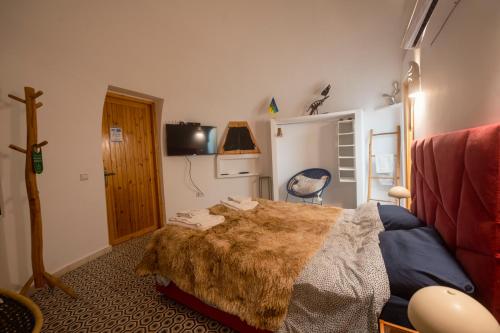 a bedroom with a bed and a tv in it at Villa Roswell Marrakech in Marrakech