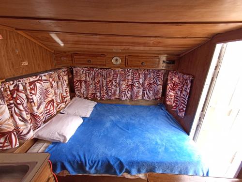 a bed in the back of a train car at Peaceful and Cozy Camper in the City Center with Private Patio in Cabo San Lucas