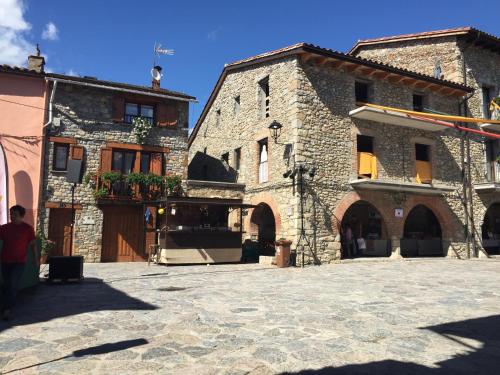 a group of stone buildings in a courtyard at La Calma de Bellver in Bellver de Cerdanya 