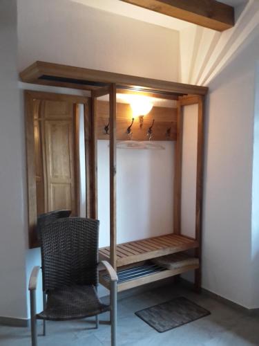 a room with a chair and a closet with birds in it at Dreiurtshof in Remplin