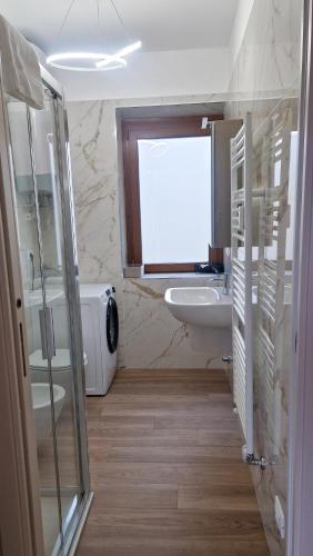 a bathroom with a sink and a toilet and a window at Bardonecchia 3-room Apartment - Frejus Palace in Bardonecchia