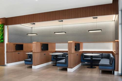 a waiting room with tables and chairs in a building at Courtyard by Marriott Kodak Sevierville in Kodak