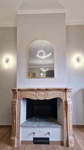 a fireplace with a mirror on top of it at Bardonecchia 3-room Apartment - Frejus Palace in Bardonecchia