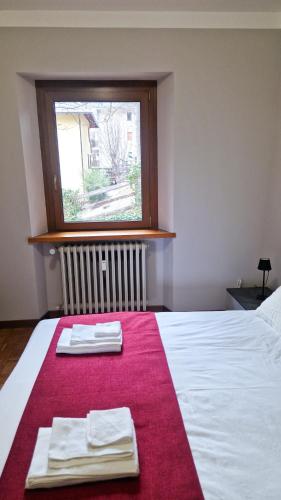 a bedroom with a bed with two towels on it at Bardonecchia 3-room Apartment - Frejus Palace in Bardonecchia