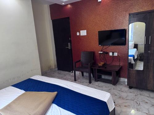 a hotel room with a bed and a television at The Fortune inn in Chennai