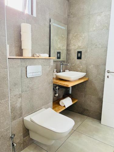 a bathroom with a toilet and a sink at Private Secluded Cosy Studio in Avalon Golf Estate in Bois Chéri