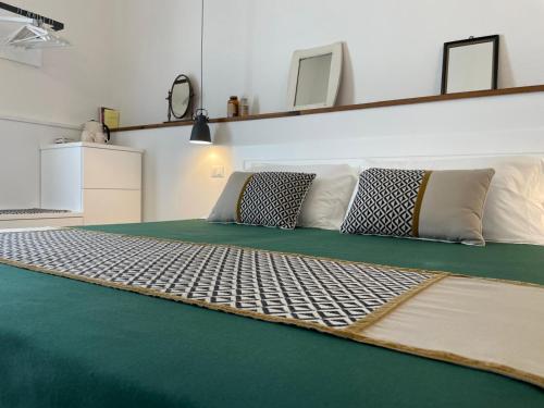 a room with a couch with two pillows on it at Dimora Ferralasco in Carloforte