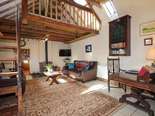 a living room with a couch and a table at Milltown House in Turriff
