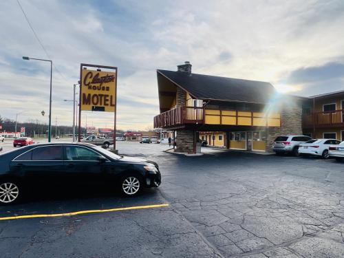a car parked in a parking lot in front of a motel at Clayton House Motel in Loves Park