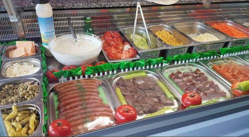 a buffet filled with different types of food in trays at Private Studio Brussels Airport in Brussels
