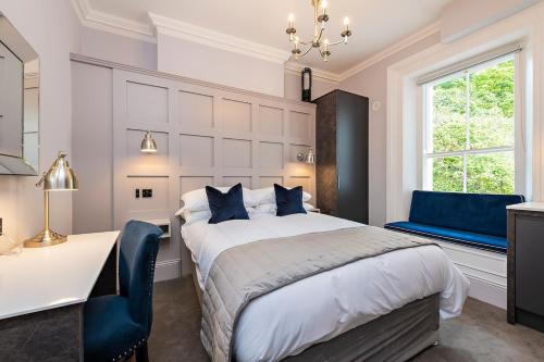 a bedroom with a bed and a desk and a window at Charming Studio at the Marina in Dublin