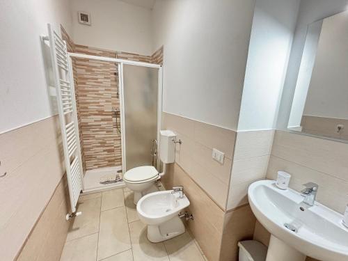 a bathroom with a toilet and a sink at IZZ1 Apartments - Motor&Food Valley - Posto Auto Privato in Formigine