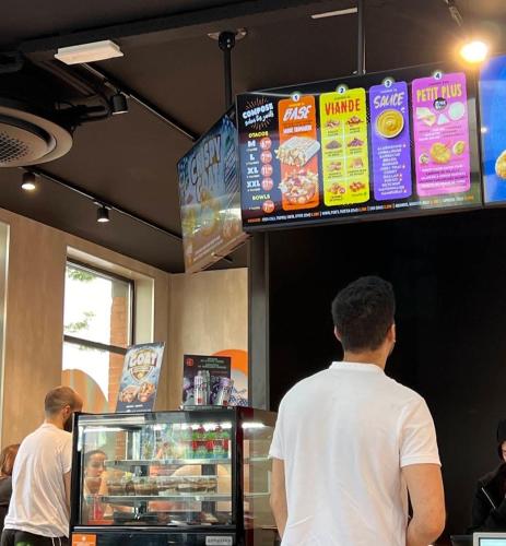 two men standing at a food counter in a restaurant at Private Studio Brussels Airport in Brussels