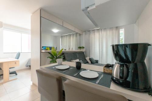 a kitchen with a table with a blender on a counter at Excelente Localização - DU301 in Maringá