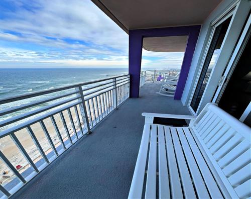 een bankje op een balkon met uitzicht op de oceaan bij Wyndham Ocean Walk Resort 2321 Vacation in Comfort and luxury - 2BR Direct Oceanfront in Daytona Beach