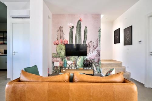 a living room with a couch and a tv at Villa Canepa in Marsala