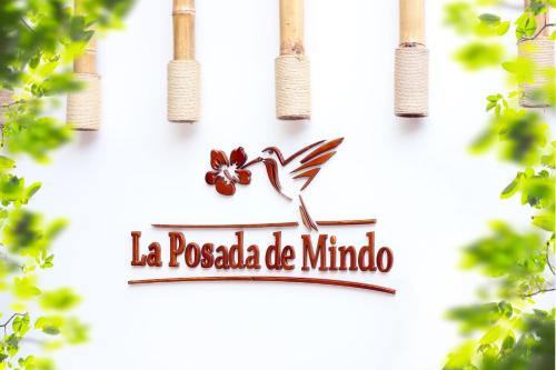 a sign for a pococola de mimo with trees at La Posada de Mindo in Mindo