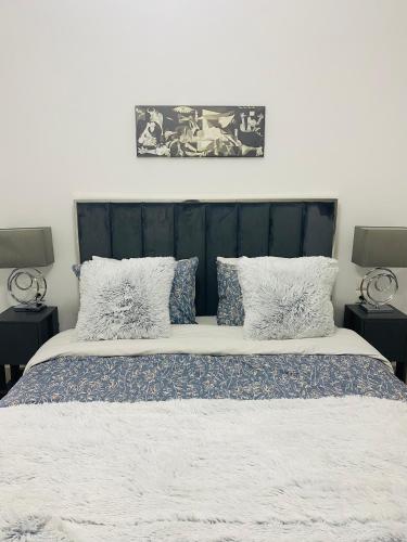 a bedroom with a large bed with pillows at New Modern 2BD aprt with shared rooftop pool B2 in Athens