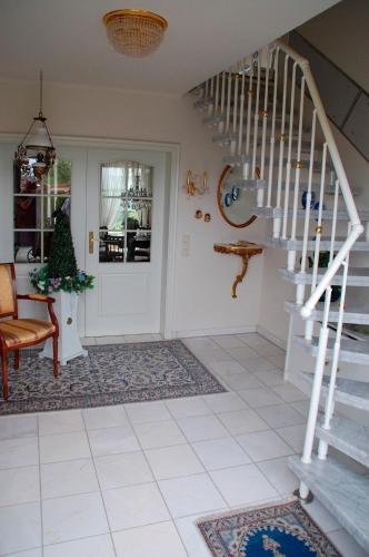 a living room with a staircase leading to the front door at Privatzimmer Ehrhardt Nr2 in Burg auf Fehmarn