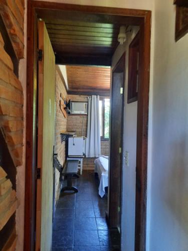 a hallway with a hallway leading to a room at Pousada Icthus in Cabo Frio