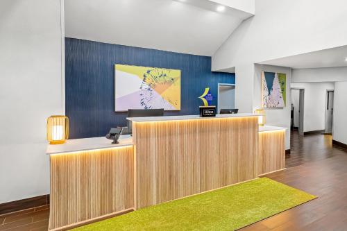 an office with a reception desk with a green rug at Spark by Hilton Oxford in Oxford