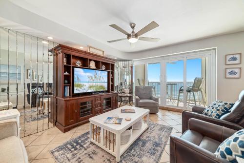 a living room with a couch and a tv at Beachfront Bliss! 1800 sq ft Spacious 3BR Sleeps 12 - Oceans 9D in Gulf Shores