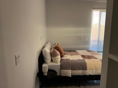 a bedroom with a bed with pillows on it at Santa Monica Bright Studio with stunning view in Los Angeles