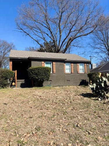 a house with a large yard in front of it at CeloVacationHousing in Memphis