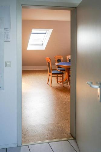 a room with a table and chairs and a skylight at Ferienwohnung Schneider in Bannesdorf