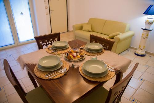 a table with plates and bowls of food on it at Amalfi Coast - House Along the Amalfi Coast -FREE PARKING in Vietri sul Mare