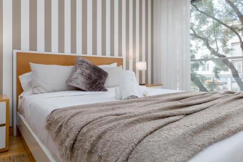 Ένα ή περισσότερα κρεβάτια σε δωμάτιο στο BeGuest Premium Lisbon Suites