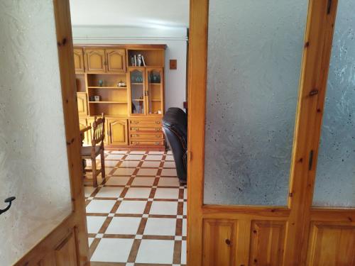 a door leading into a room with a checkered floor at Casa Marco in Gistaín