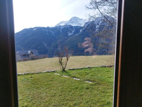a view from a window of a field with a mountain at Casa Marco in Gistaín