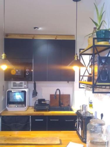 a kitchen with a sink and a microwave at Loft PLAYA -60m- & TRABAJO -online- in Almería