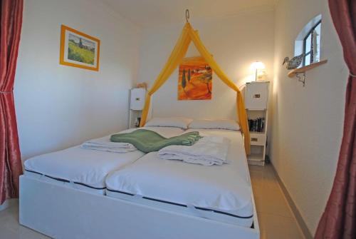 a bedroom with a bed with a canopy at Ferienwohnung Thordsen 2 in Burgtiefe auf Fehmarn 