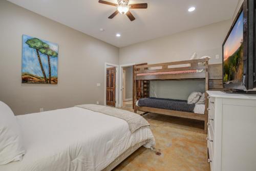 a bedroom with a bed and a tv in it at Hill Country Escape Hot Tub Pet Friendly in Dripping Springs